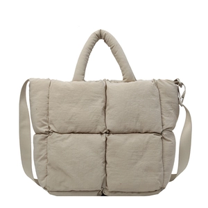 Beige quilted puffer tote bag with padded handles and adjustable shoulder strap