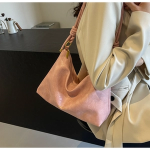 Detail of light pink Hobo tote bag with knotted shoulder strap and vintage matte texture