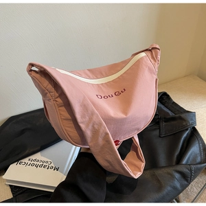 Pink nylon crescent crossbody bag with DouGu logo and white zipper detail shown on leather