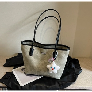 Détail du cabas vert olive avec texture délavée et charm porte-clés étoile en peluche
