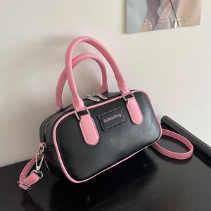 Chic black and pink color-block Boston crossbody bag with dual handles and long strap