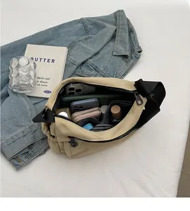 Detailed interior view of a beige nylon crossbody bag showing its large storage capacity