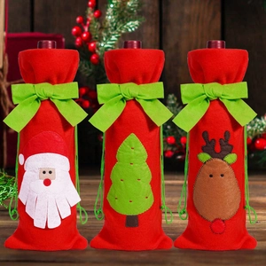 Close-up of festive red wine bottle covers with felt Christmas patterns and green bows