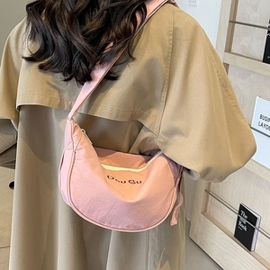 Pink nylon half-moon crossbody bag with Dou Gu embroidery and adjustable strap