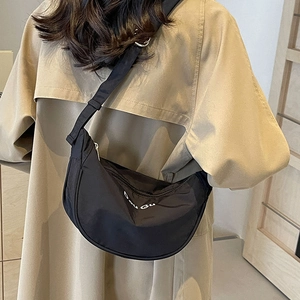 Minimalist black nylon crescent bag with Dou Gu print and adjustable shoulder strap