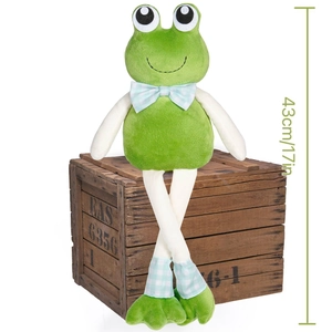 Detail of 43cm long-legged green frog plush with blue checkered bow on wooden crate