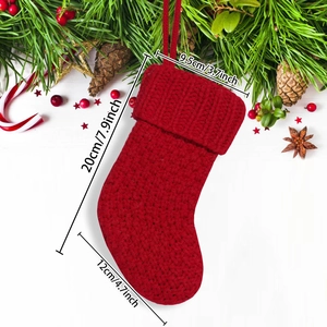Red knit Christmas stocking with cable pattern for festive holiday fireplace decoration