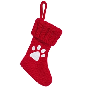 Red knitted Christmas stocking with white pet paw print and hanging loop for tree decor