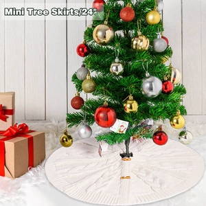 Detail of white cable knit Christmas tree skirt with wooden buttons and warm holiday decor