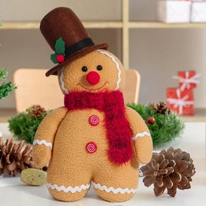 Detail of gingerbread man plush doll with chef hat and red scarf in festive setting