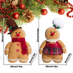 Pair of plush gingerbread dolls with chef hats and festive Christmas decorations