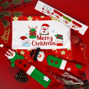Detail of Christmas fridge handle covers with snowman design and festive kitchen decor