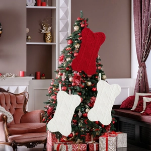 Macro shot of knitted bone-shaped Christmas stockings with cable patterns and hanging loops