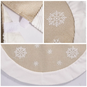 Brown burlap Christmas tree skirt with plush white snowflake prints and velvet edging