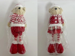 Close-up of Christmas teddy bear plush toys in festive red outfits and striped scarves