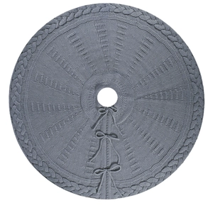 Grey knitted Christmas tree skirt with cable knit patterns and decorative bow ties