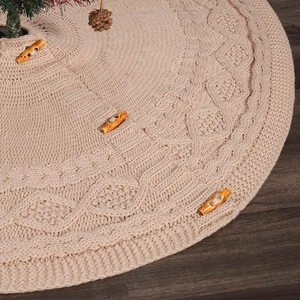 Macro detail of beige cable knit Christmas tree skirt with decorative wooden buttons