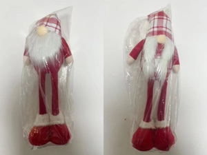 Detail of red and white checkered plush Christmas gnomes with long legs in packaging