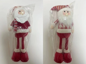 Detail of red Christmas plush dolls with long legs and cozy fabric boots for holiday decor