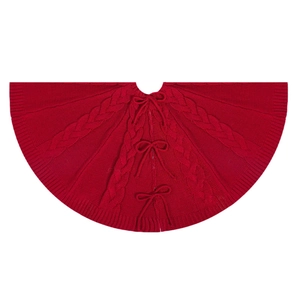 Classic red cable knit Christmas tree skirt with decorative bow ties on white background