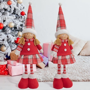 Detail of cute Christmas girl elf dolls with red plaid hats and braided hair ornaments