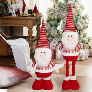 Close-up of red and white striped plush gnome dolls in a cozy Nordic Christmas setting