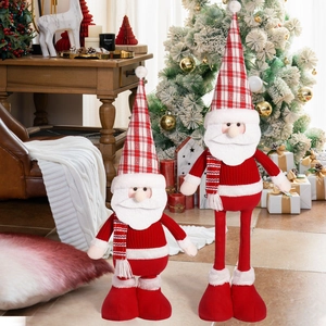 Detail of red Santa Claus plush dolls with long legs and cozy hats for holiday decor