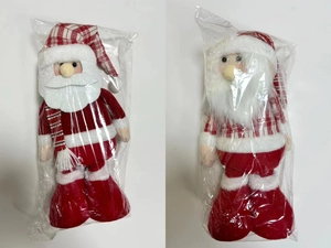 Detailed view of a 20-inch Santa Claus doll with red plaid hat in plastic packaging