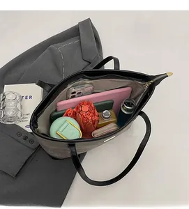 Top view of spacious black tote bag interior showing large capacity for laptop and daily items