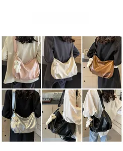 Detail view of stylish pleated crescent bags in five colors with cute bear charms