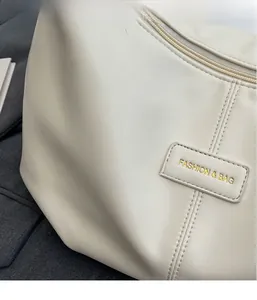 Detailed macro view of white textured leather surface with Fashion & Bag label and metal zipper
