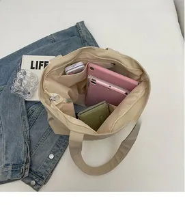 Interior view of beige canvas tote bag showing spacious storage for tablet and wallet