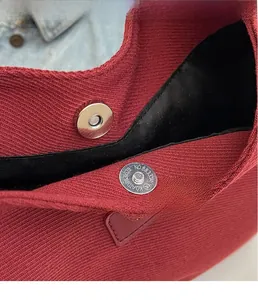 Detail view of the vintage canvas bag showing the magnetic hardware clasp and lining