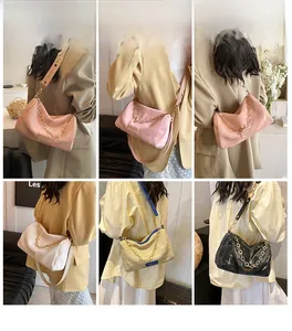Detail view of stylish Boston bags in various colors with metallic gold star chain detail