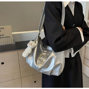 Silver pleated tote bag with metallic sheen and cute plush bear charm detail
