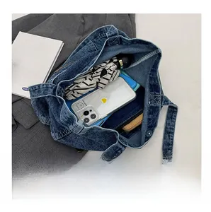 Detail view of large denim tote bag interior showing spacious capacity for daily items