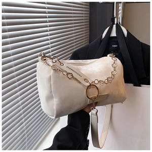 Detail of cream Boston bag featuring suede texture and gold star shaped metal chain