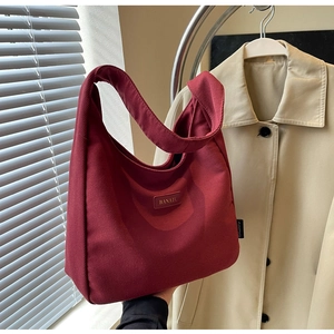 Close-up of a burgundy canvas hobo bag with Banatu logo tag and durable fabric texture