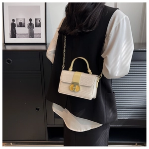 Model wearing a white crocodile texture crossbody flap bag with gold metal buckle