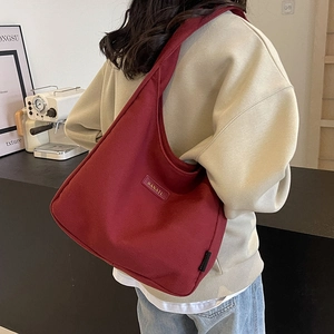Burgundy corduroy tote bag with large capacity for women on model in lifestyle setting