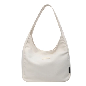 Minimalist off-white canvas crescent tote bag with leather logo for women
