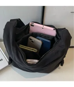 Detailed interior of the black nylon crossbody bag showing multiple storage compartments