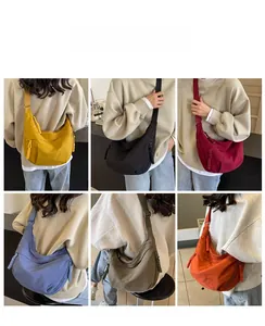 Detail view of canvas crescent tote bags in six colors including ginger and burgundy