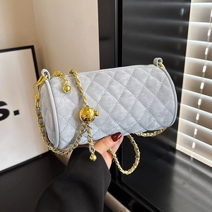 Light blue quilted cylinder bag with gold chain strap and ball buckle detail