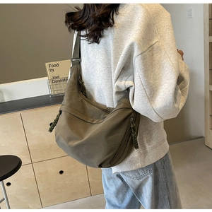 Army green nylon crossbody bag showing the adjustable wide shoulder strap and side view