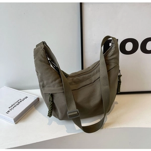 Olive green nylon hobo bag featuring woven rope zipper pulls and an adjustable shoulder strap