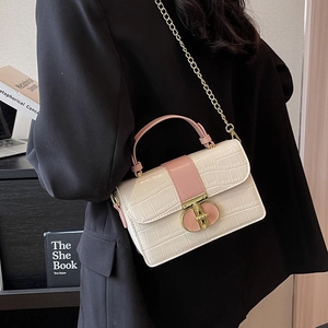 Chic cream and pink croc-effect chain crossbody bag shown on a model for modern styling