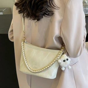 Cream bucket bag with crackle texture, metal chain strap and plush cloud charm