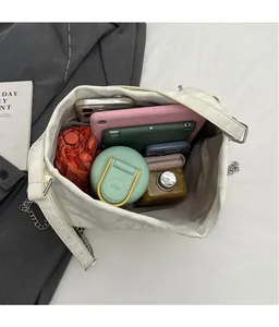Macro view of white leather tote bag interior showing large capacity for tablet and items