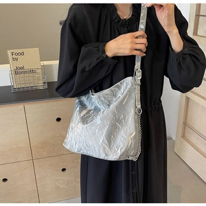 Silver metallic wrinkled texture hobo bag with adjustable strap on a model